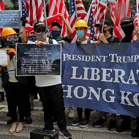 Thousands of Hong Kong demonstrators marched to the U.S. Consulate on Sunday, urging President Donald Trump to help 