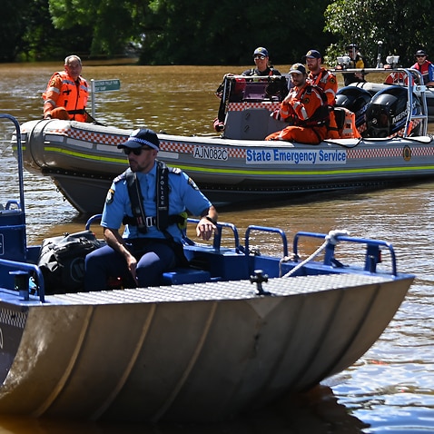 NSW State Emergency Service workers and police are seen in boats amid flooding in the suburb of Windsor, north west of Sydney on Wednesday.