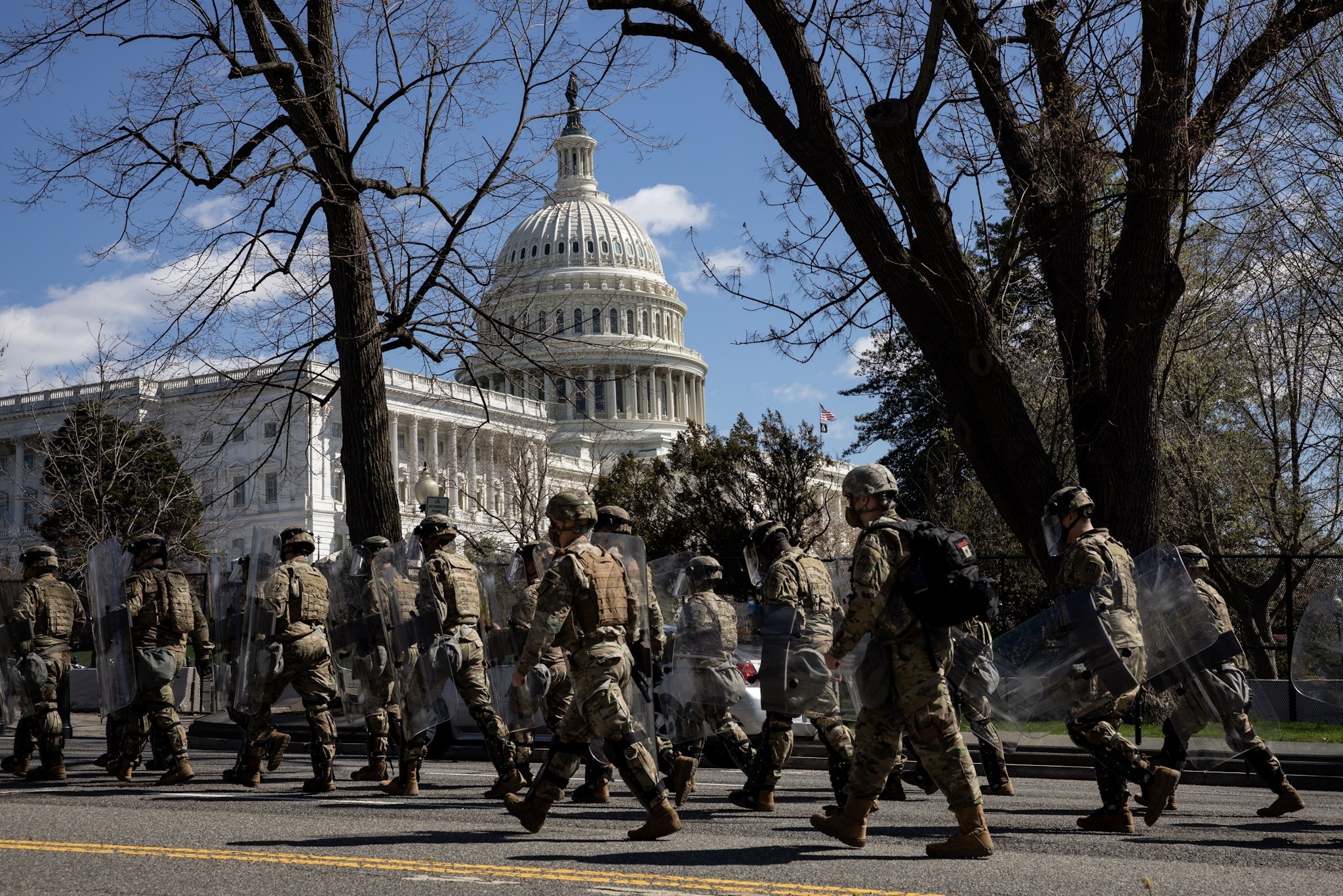 US Capitol police officers and National Guard troops walk near the scene after the attack on Friday.