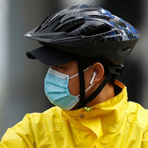 A delivery rider wearing a face mask is seen in Melbourne, Thursday, June 25, 2020. The ADF and other states have been called in to help Victoria tackle its rising number of COVID-19 cases. (AAP Image/Daniel Pockett) NO ARCHIVING