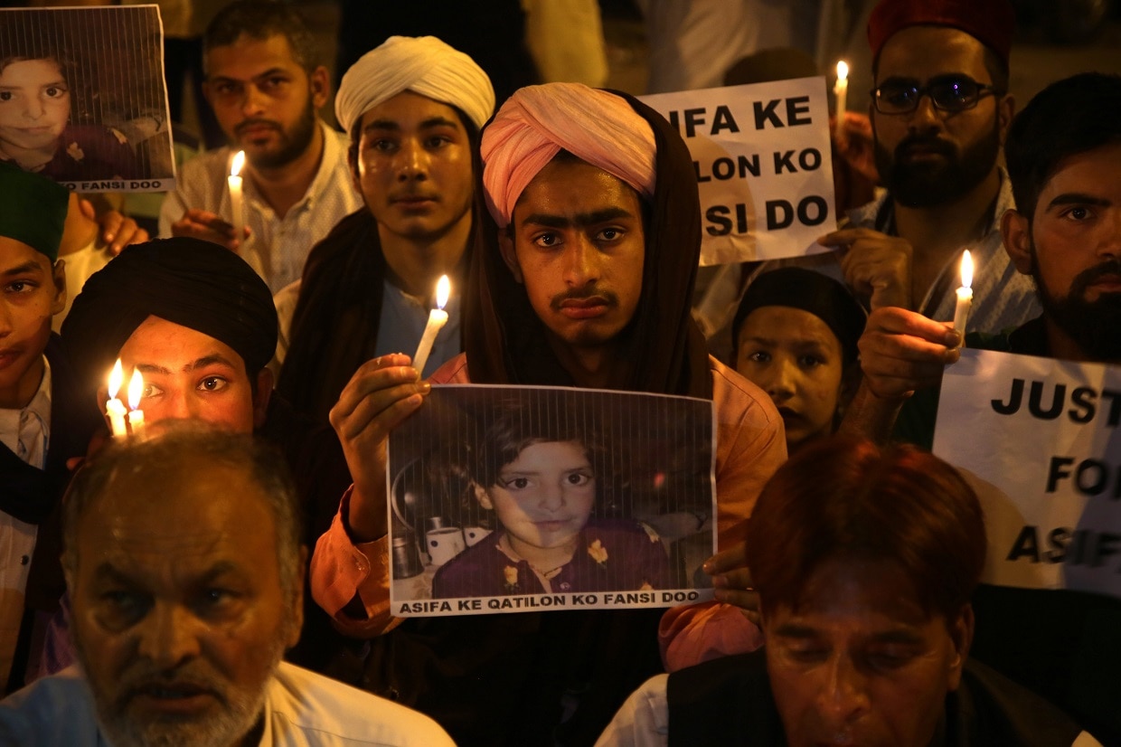 A protestor holds up an image of Asifa Bano at a demonstration in Jammu.