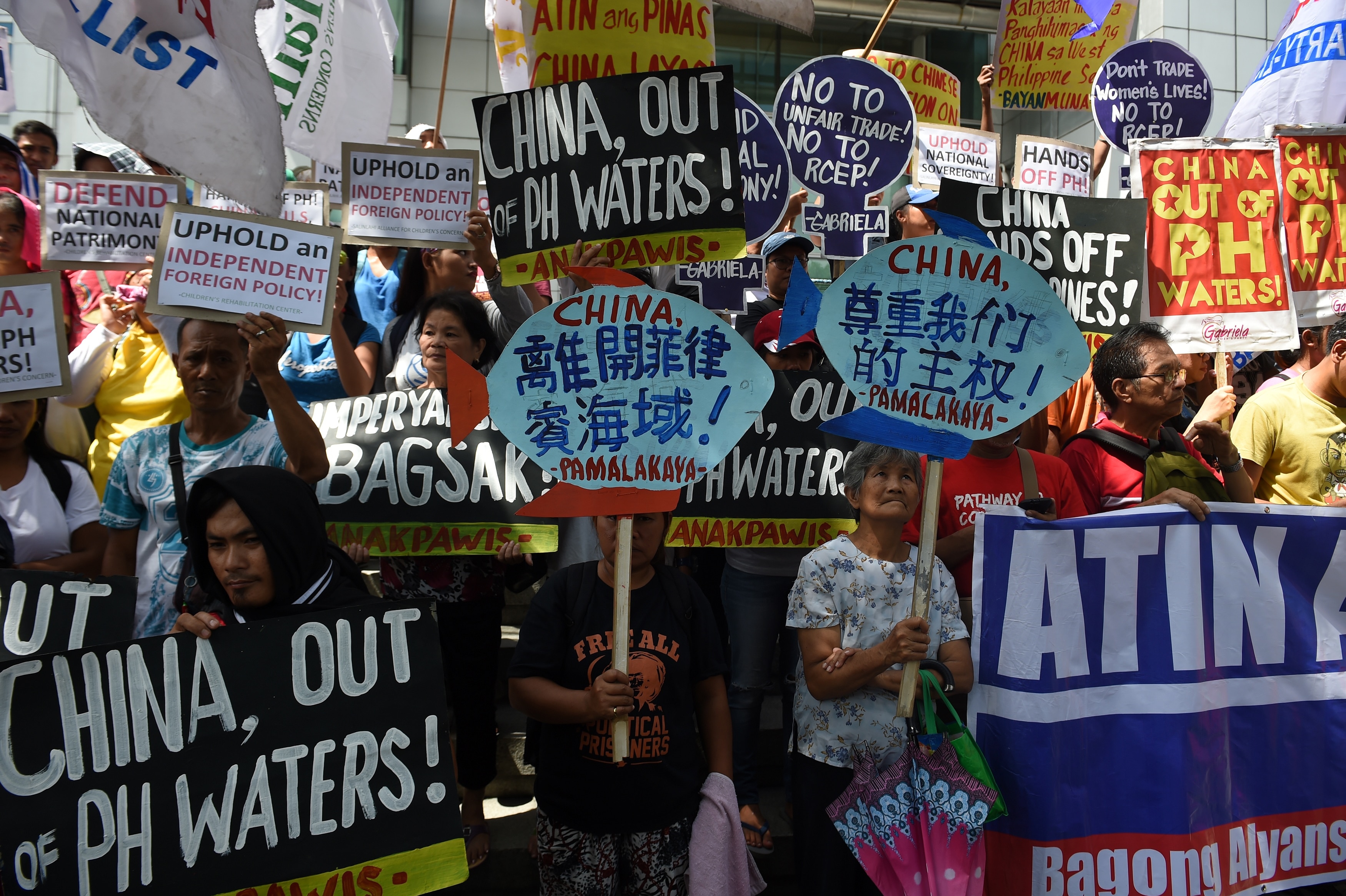 Protesters holding placards and streamers shout anti-China slogans during a protest against China's presence in disputed waters in the South China Sea.
