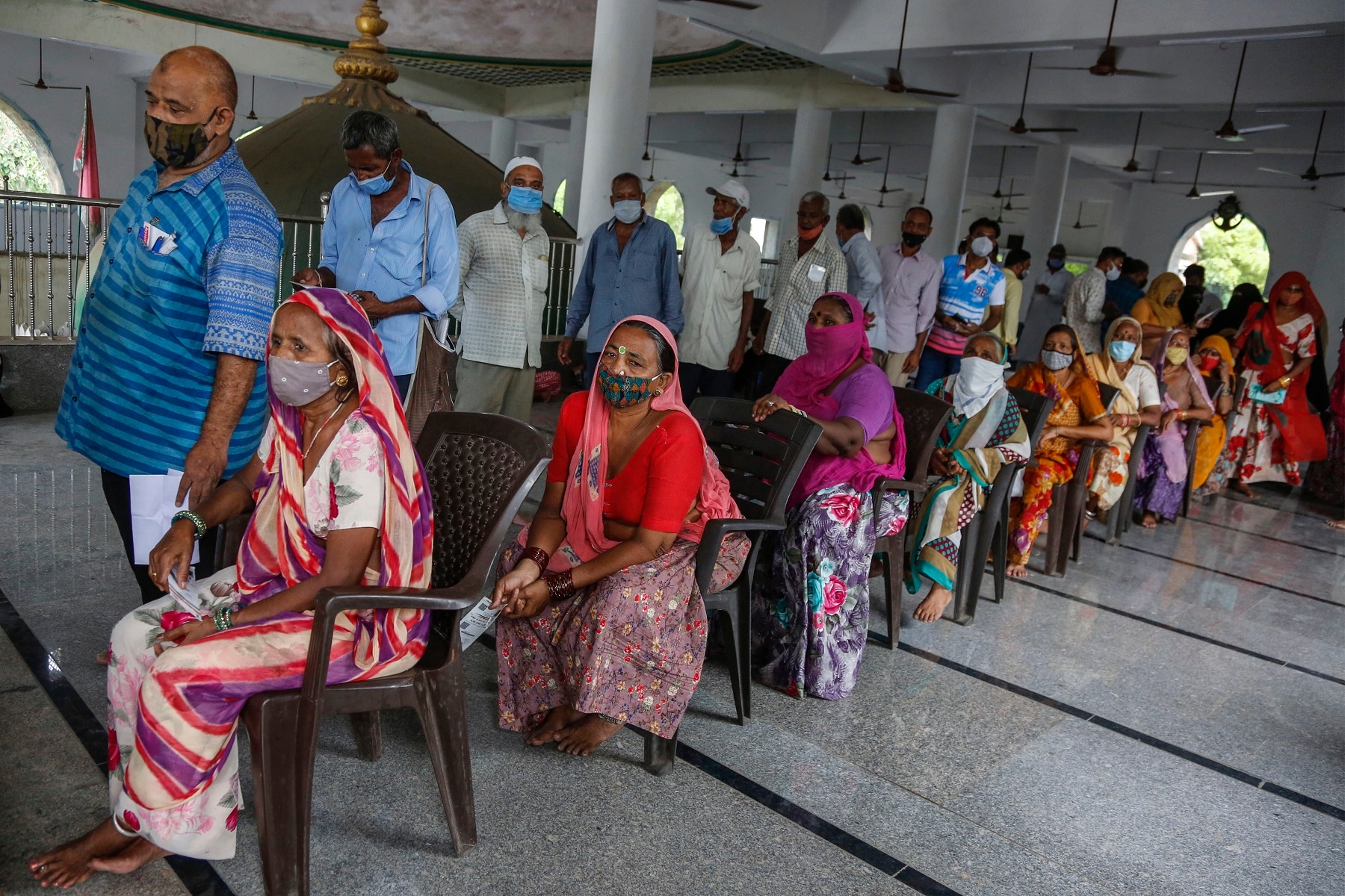 People line up to register themselves to get a dose of Covishield, Serum Institute of India's version of the AstraZeneca COVID-19 vaccine.
