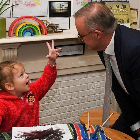 Australian Opposition Leader Anthony Albanese speaks to a child during a visit to a Goodstart Early Learning Childcare Centre on Day 39 of the 2022 federal election campaign in Sydney, Thursday, May 19, 2022. (AAP Image/Lukas Coch) NO ARCHIVING