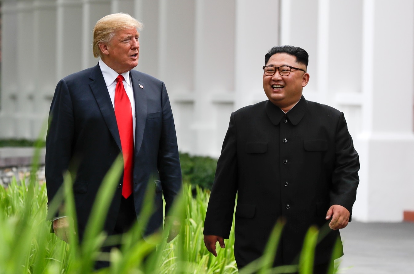 US President Donald Trump and North Korea leader Kim Jong-un walk from their lunch at the Capella resort on Sentosa Island Tuesday, June 12, 2018