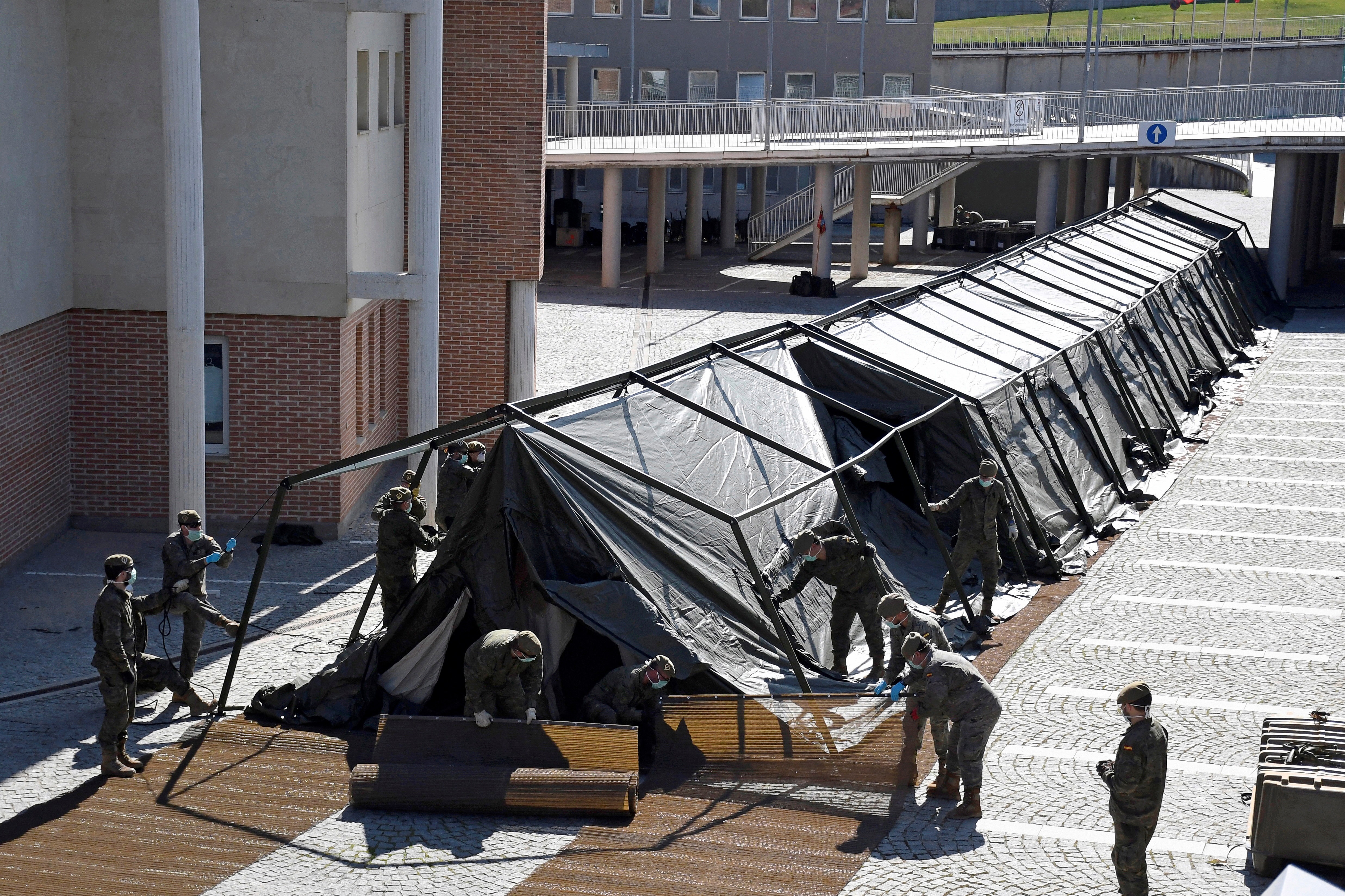 Spain's ground army engineers build a tent for a field hospital next to the Segovia Hospital in Segovia, Spain