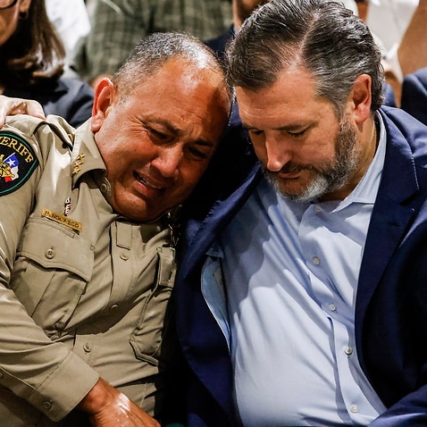 Uvalde County Sheriff Ruben Nolasco (L) cries, as he is comforted by US Senator Ted Cruz  