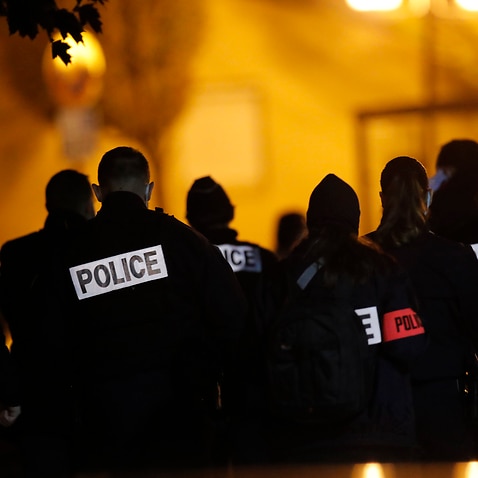 French police officers gather outside the high school