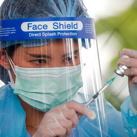 A Thai health official prepares the AstraZeneca COVID-19 shot at a vaccination facility in Bangkok, Thailand, on 16 July, 2021.