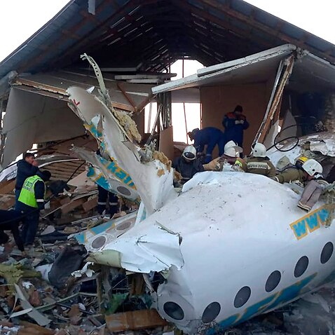Rescuers get to work at a plane crash near Almaty International Airport, outside Almaty, Kazakhstan.