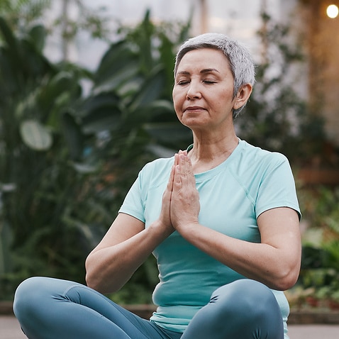 Woman sitting cross-legged, meditating