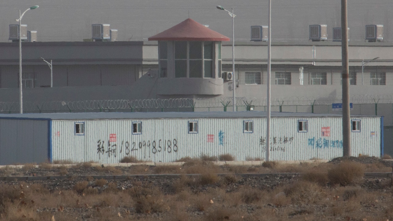 A guard tower and barbed wire fences are seen around a facility in the Kunshan Industrial Park in Artux in western China's Xinjiang region. 