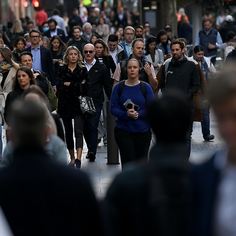 Crowds of people are seen in the central business district of Sydney