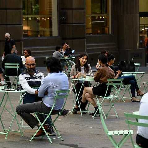 Members of the public sit at outdoors dining areas in the central business district (CBD) of Sydney, Monday, 18 October, 2021. 