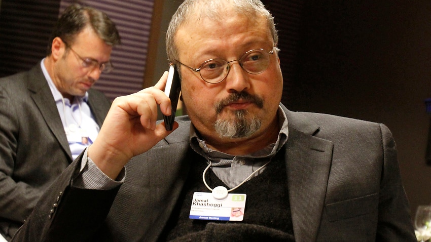 In this 29 January, 2011, file photo, Saudi Arabian journalist Jamal Khashoggi speaks on his cellphone at the World Economic Forum in Davos, Switzerland.