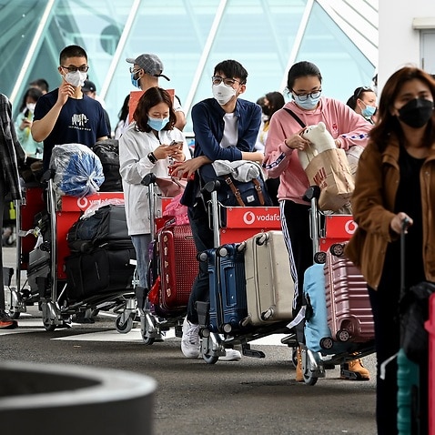 International students wear face masks as they arrive at Sydney Airport in Sydney, Monday, December 6, 2021.