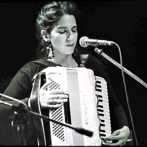 Greek musician Avgerini Gatsi playing accordion. 