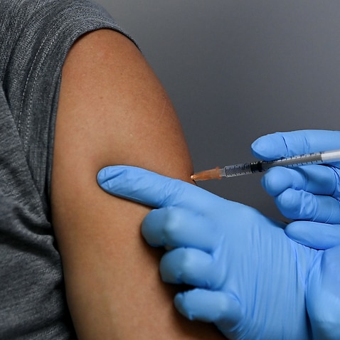 A patient receives the Pfizer COVID-19 vaccination by a nurse at the Belmore Medical GP in the suburb of Belmore, Sydney, Saturday, August 28, 2021.
