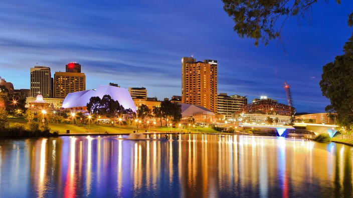 Adelaide city CBD at sunrise reflecting in still waters of torrens river