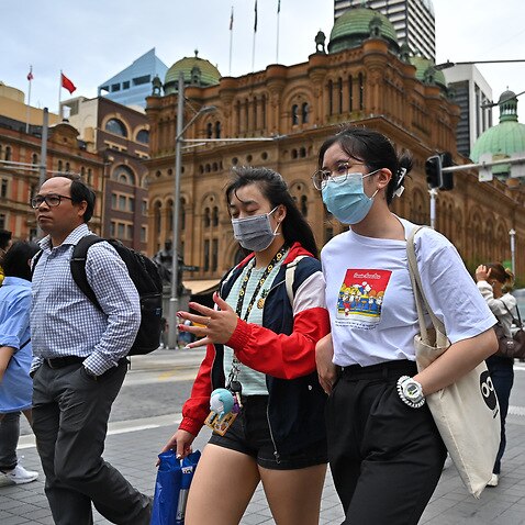 People wearing masks on George Street, Sydney.