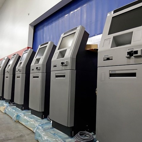 In this Wednesday, Aug. 30, 2017, photo, automated teller machines are lined up during the manufacturing process at Diebold Nixdorf in Greensboro, N.C. (AP Photo/Gerry Broome)