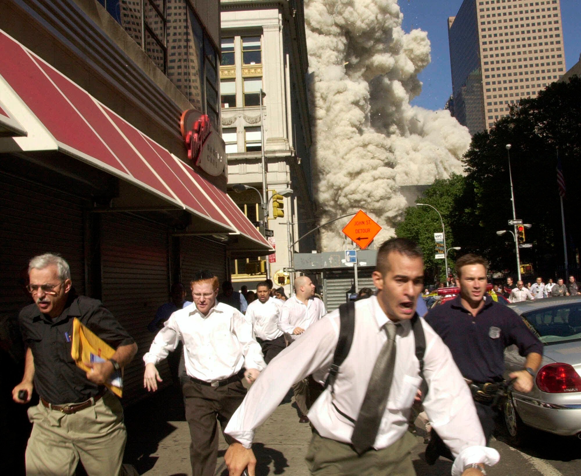 People run from the World Trade Center on 11 September 2001.
