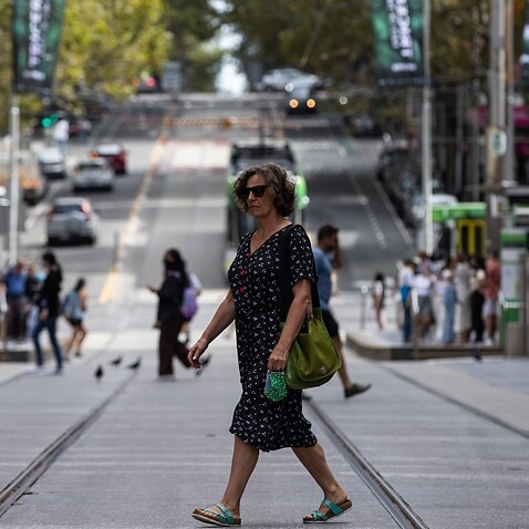 People walk along Bourke Street Mall in Melbourne, Sunday, March 20, 2022. (AAP Image/Diego Fedele) NO ARCHIVING