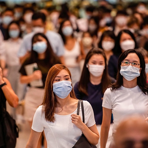 Commuters wearing face masks at the Central MTR subway station in Hong Kong