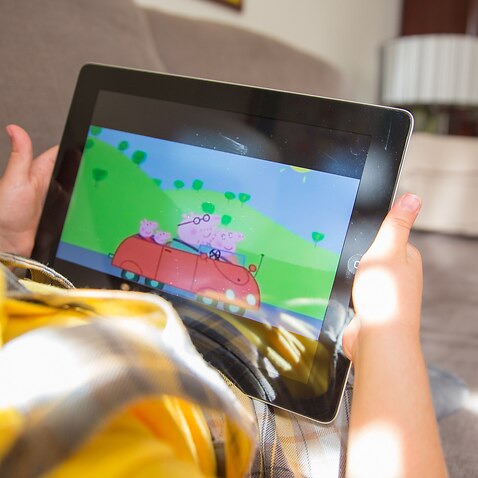 Child watching Peoppa pig on tablet