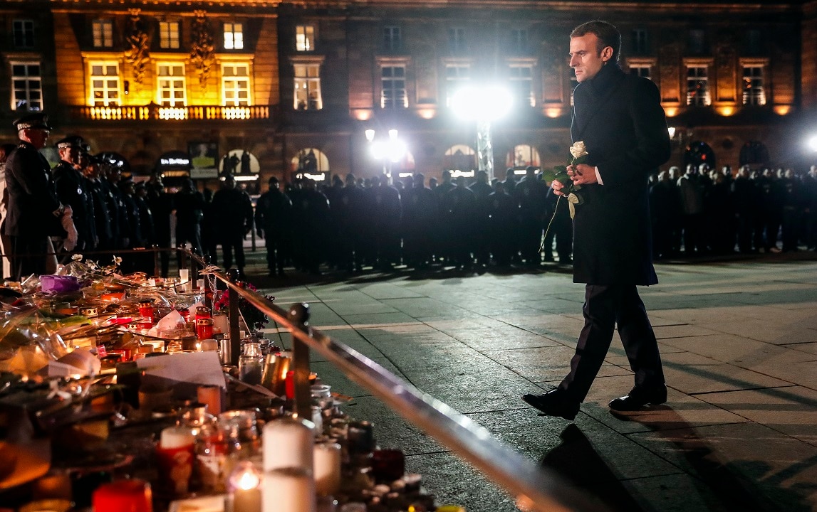 French President Emmanuel Macron pays his respects to the victims of the Christmas market terror attack in Strasbourg.
