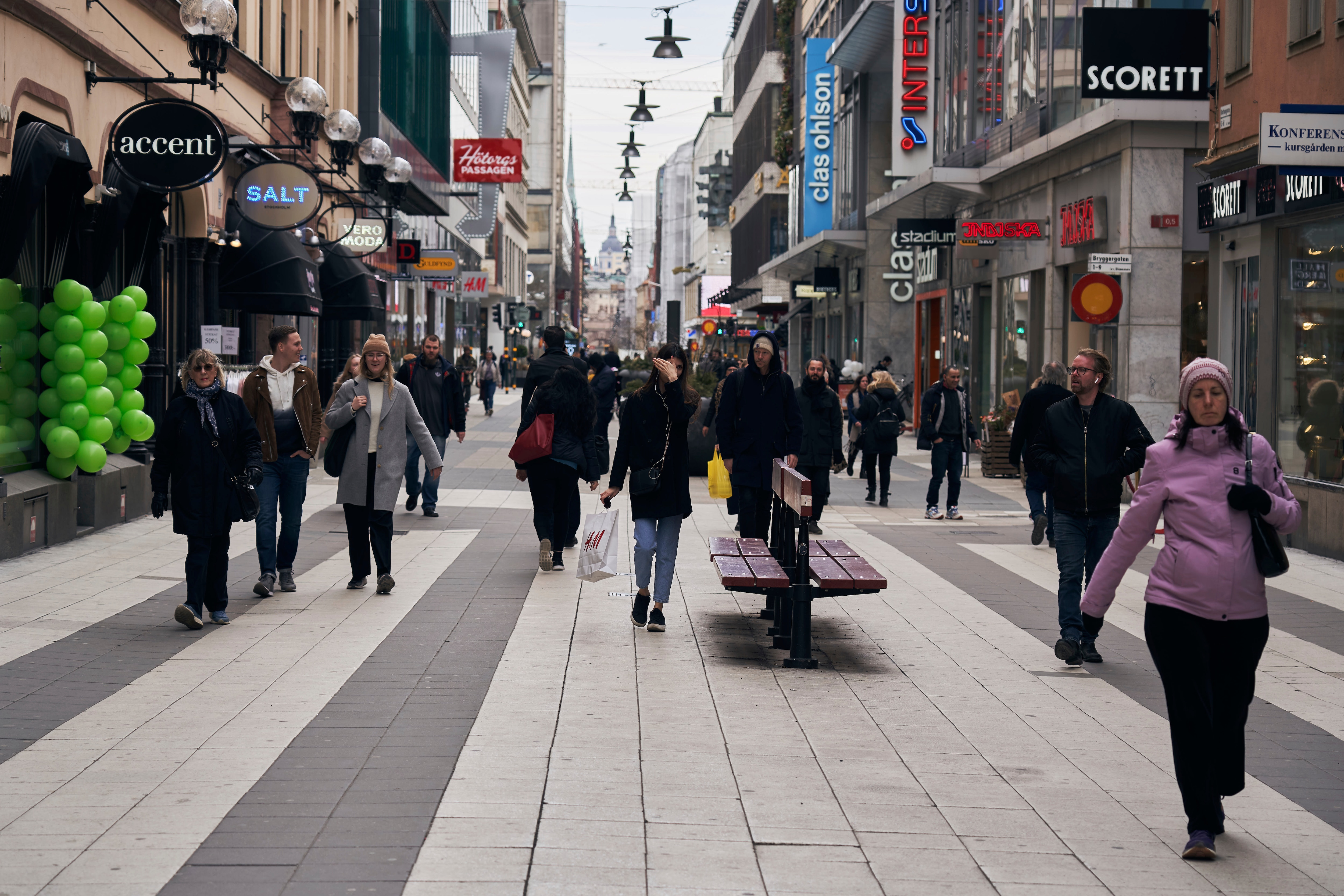 People walk along the main pedestrian shopping street in Stockholm, Sweden, Wednesday, March 25, 2020. The streets of Stockholm are quiet but not deserted. 