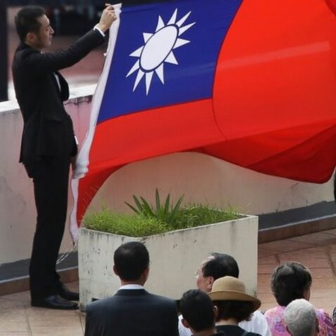 Members of the Taiwan embassy in Panama attend a ceremony where they folded the Taiwanese flag, at their embassy in Panama City, (ABC/ AP Photo/Arnulfo Franco)