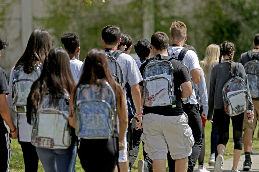 Students wear clear backpacks outside of Marjory Stoneman Douglas High School in Parkland, Florida. 