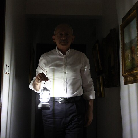 Handout photos made available by the Republican People's Party (CHP) press office shows, main opposition Republican People's Party (CHP) leader Kemal Kilicdaroglu works with a hand lamp at his apartment, 