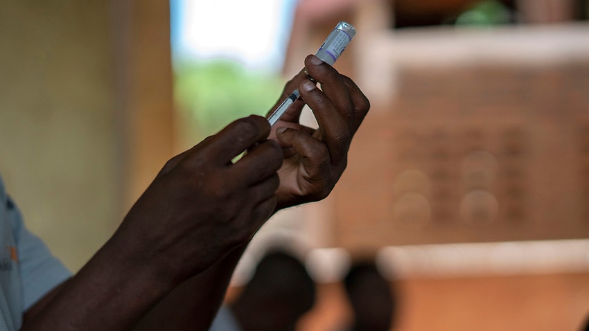 Health officials prepare vaccines in the Malawi village of Tomali in December 2019, where children were test subjects for the world's first malaria vaccine.