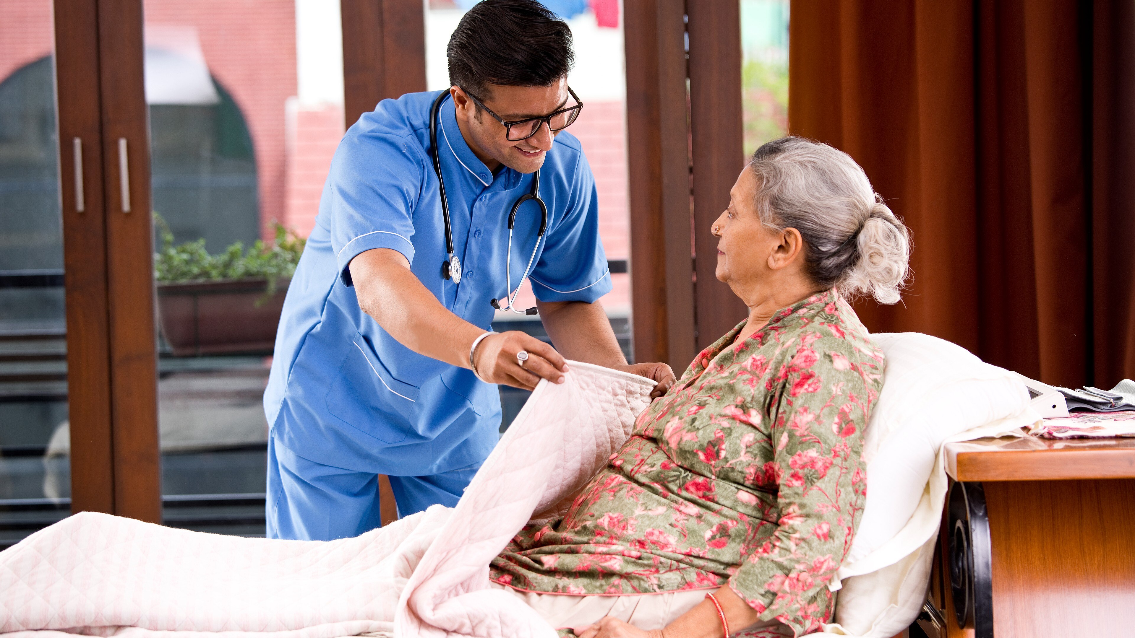 Aged care worker helping elderly in home care