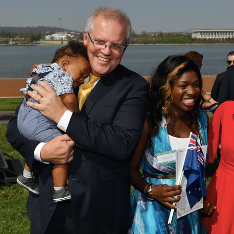 Prime Minister Scott Morrison poses for photos with new citizens during an Australia Day Citizenship Ceremony and Flag Raising event in Canberra, Jan 26, 2020