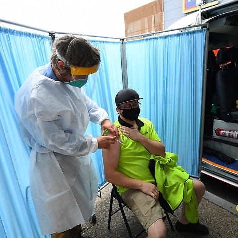 A healthcare worker speaks to a patient after administering a Covid19 vaccination at a pop-up vaccination van in Epping, Melbourne.