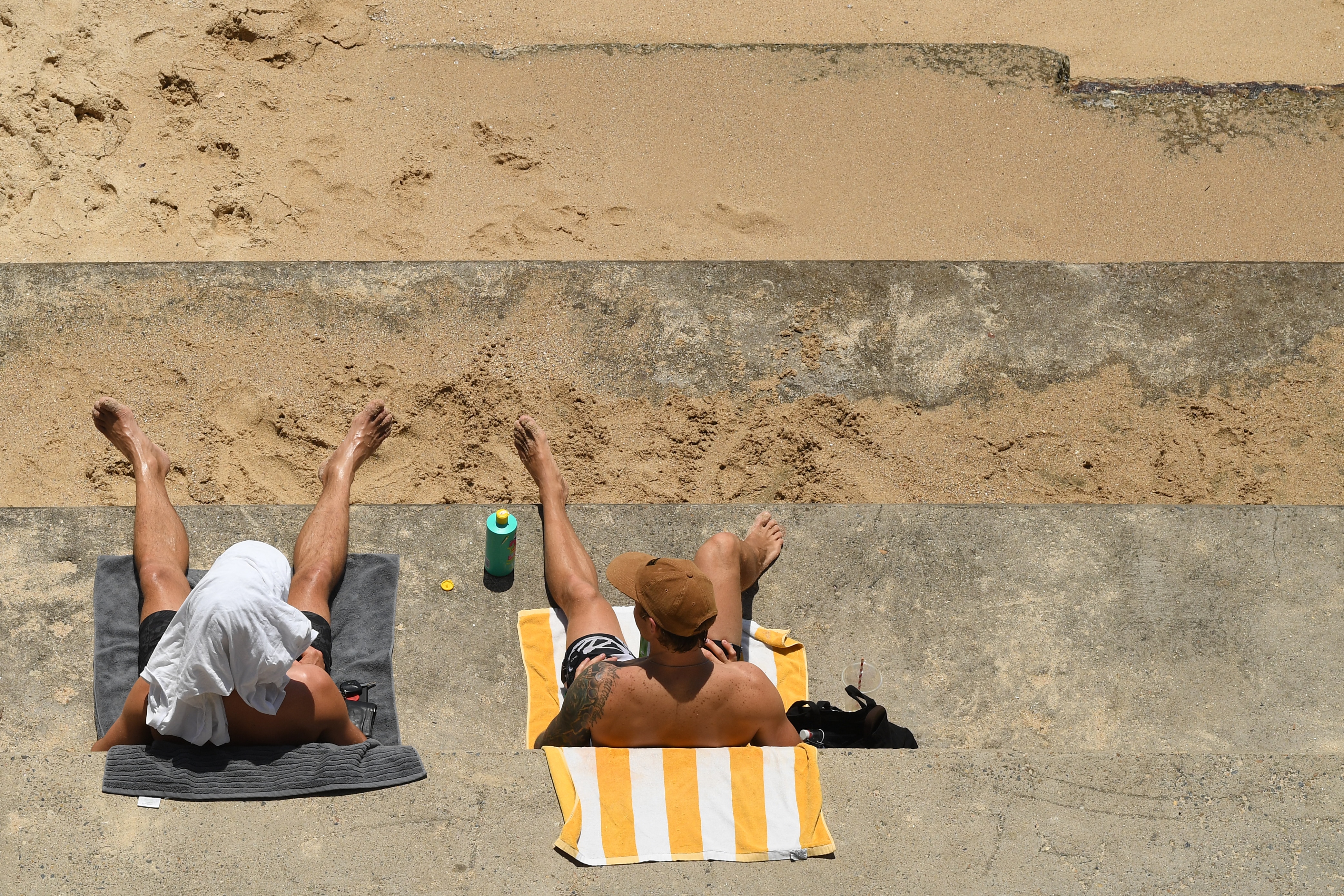 People sunbake at Bondi Beach in Sydney on Saturday, 28 November.