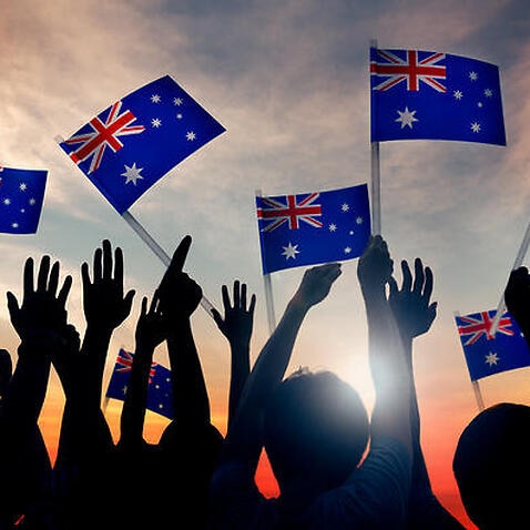 Group of people waving Australian flags