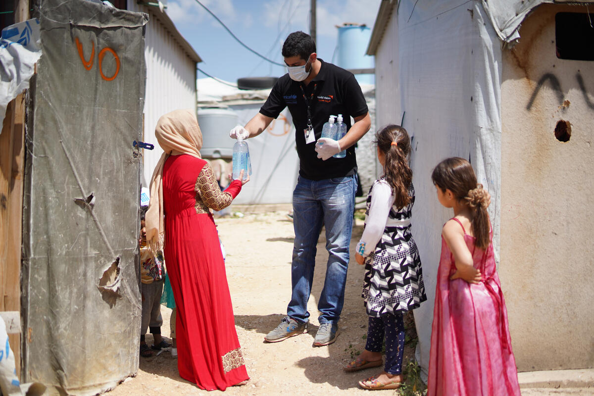 Receiving hand sanitizer in Beqaa refugee camp. Receiving hand sanitizer in Beqaa refugee camp