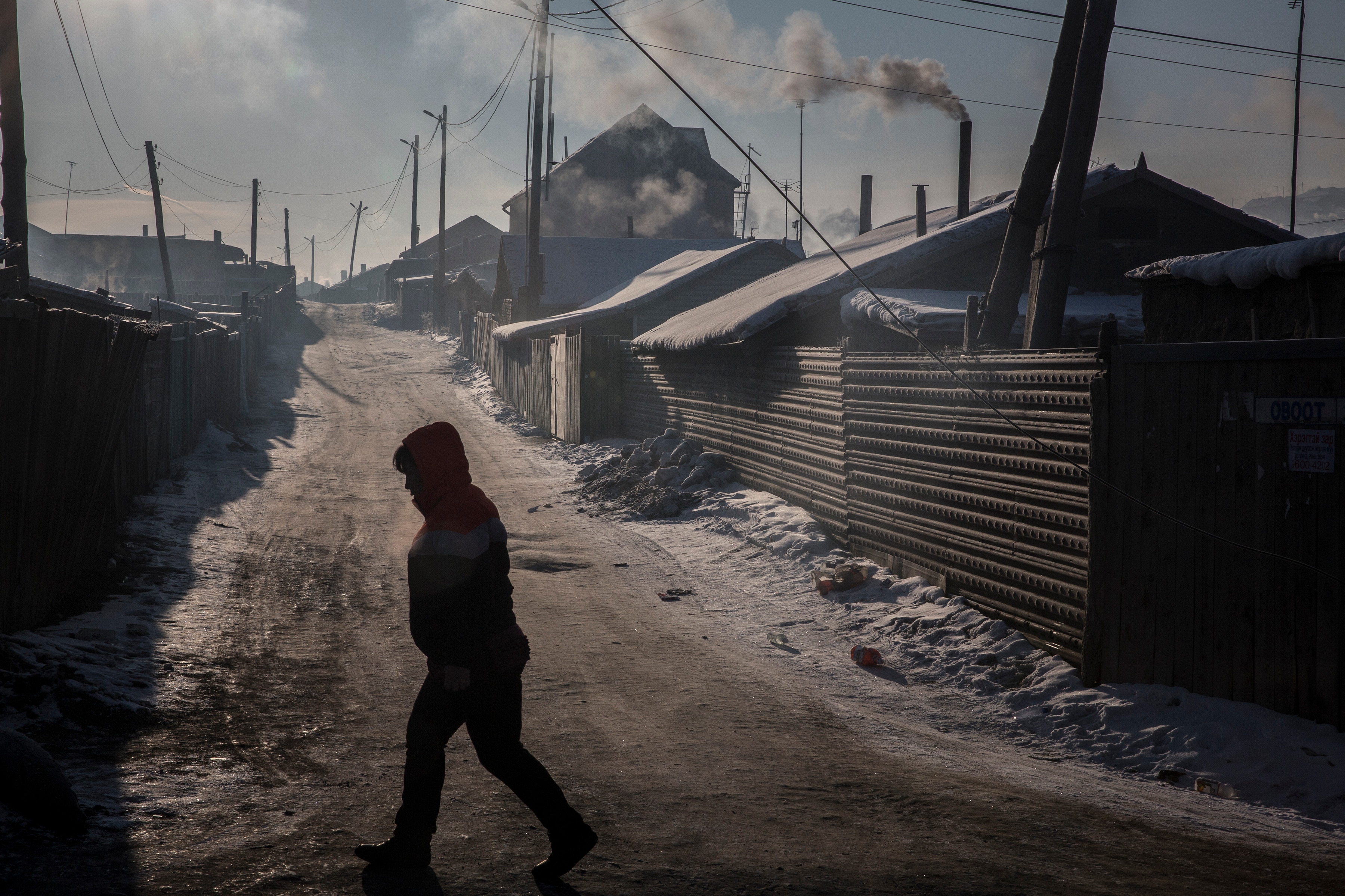 On a day of heavy pollution, a resident walks through the Bayankhoshuu District of northern Ulaanbaatar, Mongolia. On a day of heavy pollution, a resident walks through the Bayankhoshuu District of northern Ulaanbaatar, Mongolia.