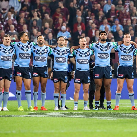 QLD Maroons and NSW Blues players line up for the National Anthem before Game 1 of the 2019 State of Origin series. 
