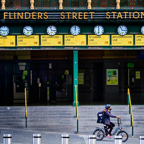 People walk past Flinders station  in Melbourne, Monday, 9 August, 2021. 