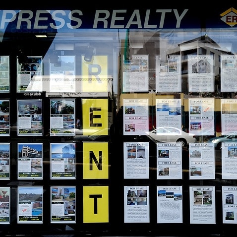 Houses for sale and lease are advertised in the window of a real estate agent at Bondi in Sydney