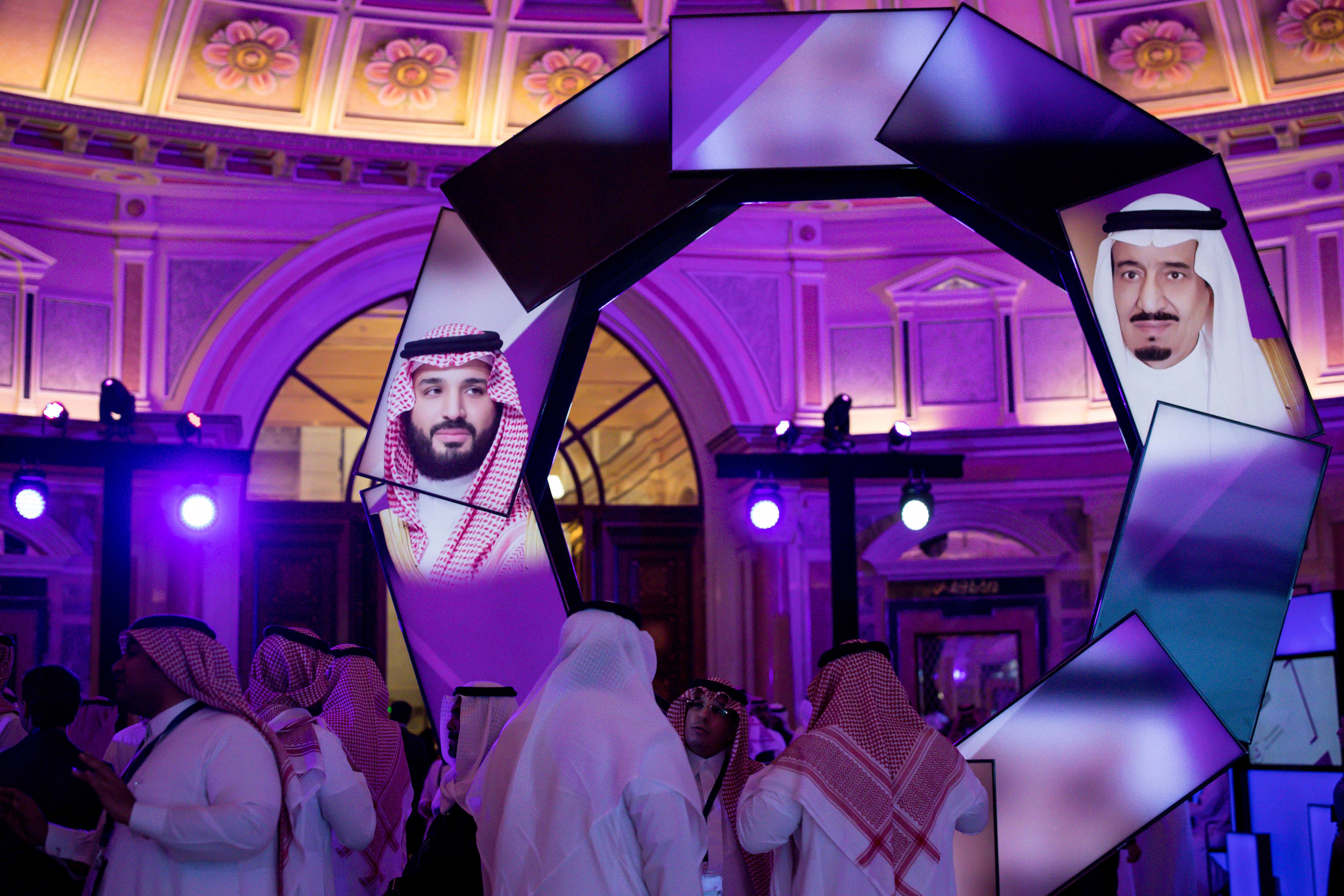 According to one of Saudi Arabia's top daily newspapers the government is studying the prospect of removing the guardianship requirement for women over age 18. Images of King Salman, right, and his son Crown Prince Mohammed bin Salman projected on screens during a conference at the Ritz-Carlton in Riyadh, Saudi Arabia, Jan. 28, 2019. (Tasneem Alsultan/The New York Times)