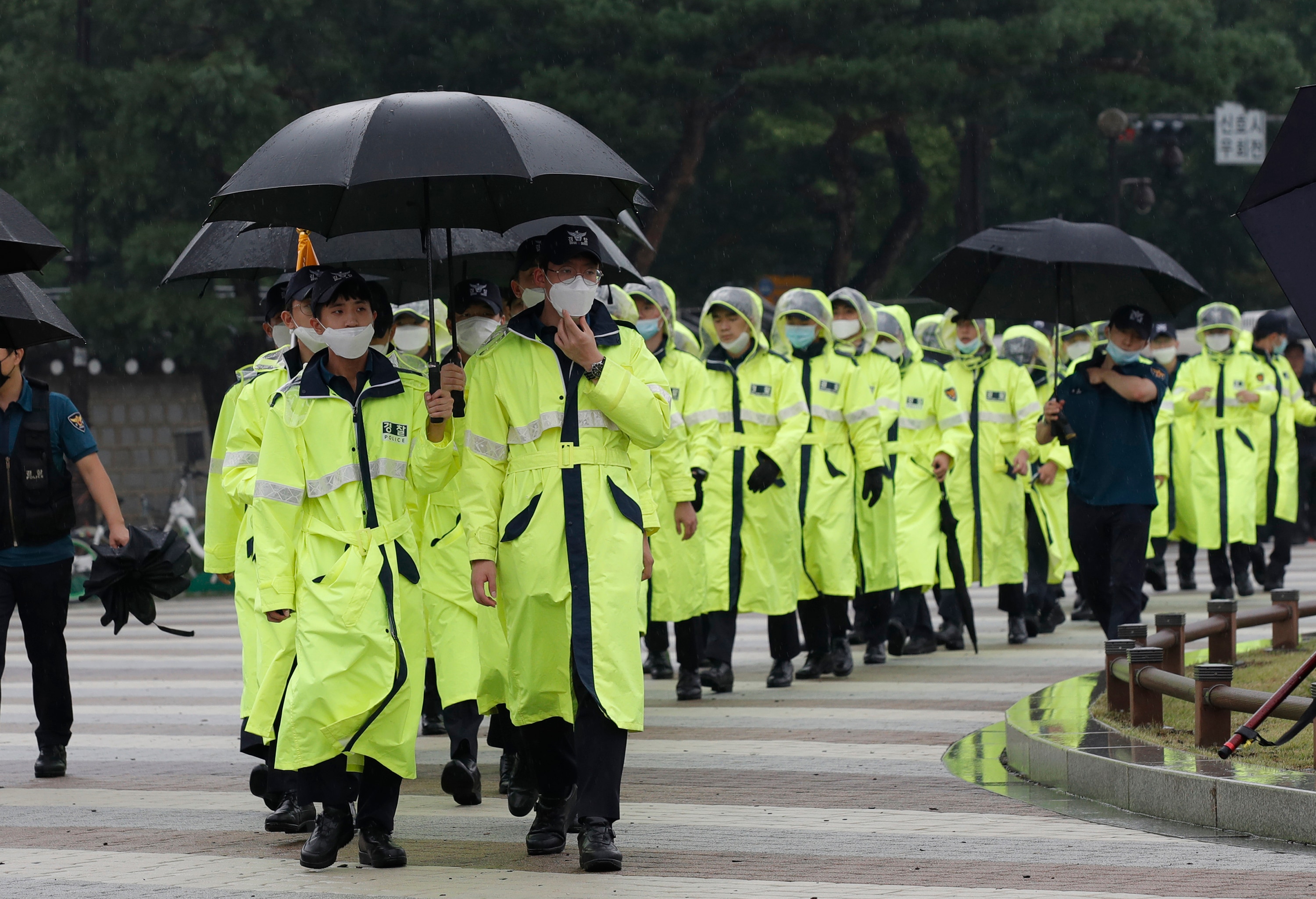 South Korean police officers wearing face masks walk in Seoul, Saturday. South Korean police officers wearing face masks walk in Seoul, South Korea, Saturday, August 15, 2020