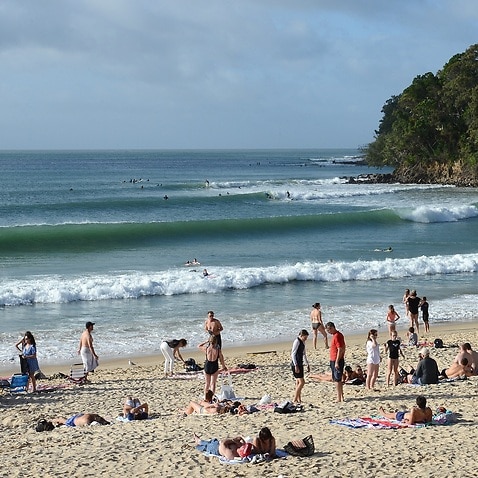 Beachgoers are seen on Noosa Beach in the resort town of Noosa Heads on the Sunshine Coast, Wednesday, July 3, 2013. (AAP Image/Dave Hunt) NO ARCHIVING