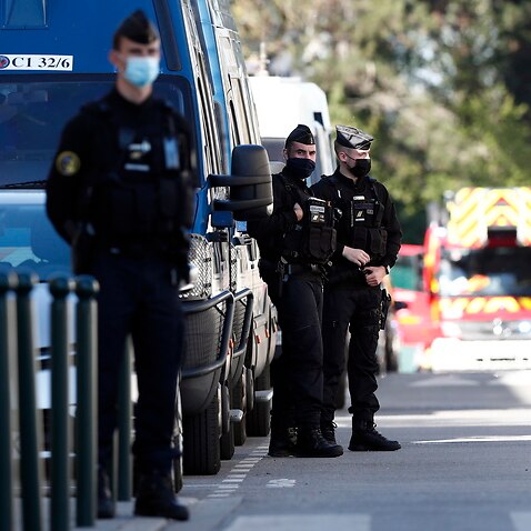 French police officers secure the street near the Police Station in Rambouillet, France, 23 April 2021, following a knife attack.