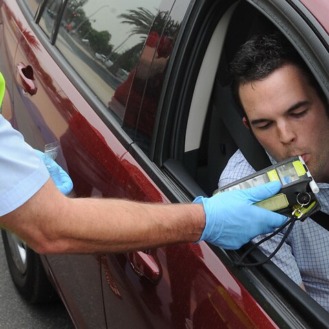 Police perform a random breath test (RBT) on a driver in the Docklands precinct in Melbourne, Friday, Nov. 20, 2009. Victoria police today launched the the road safety initiative 